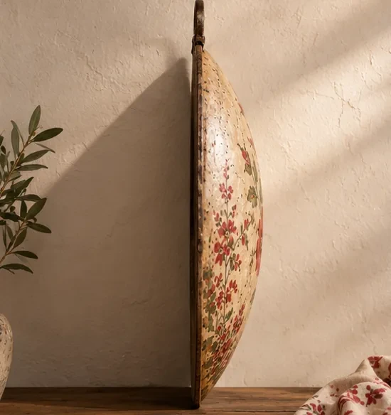 Side view showing the curved profile and depth of an unpainted metal saj.